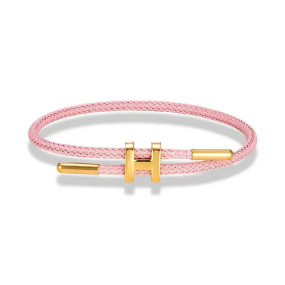 TwistMe verstellbares Damen Armband mit Charm aus rosa geflochtenem Seil und goldenen Metallakzenten